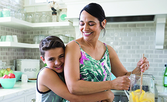 Mom and son in the kitchen making lemonade